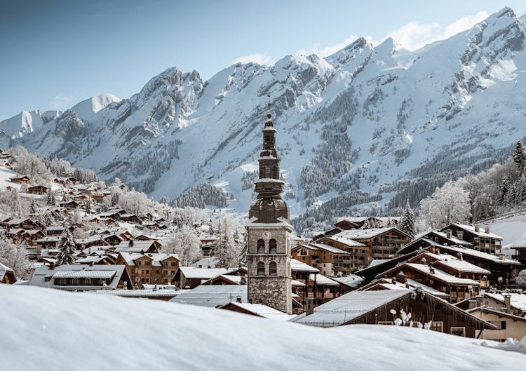 Traditional church tower in snowy winter ski resort of La Clusaz