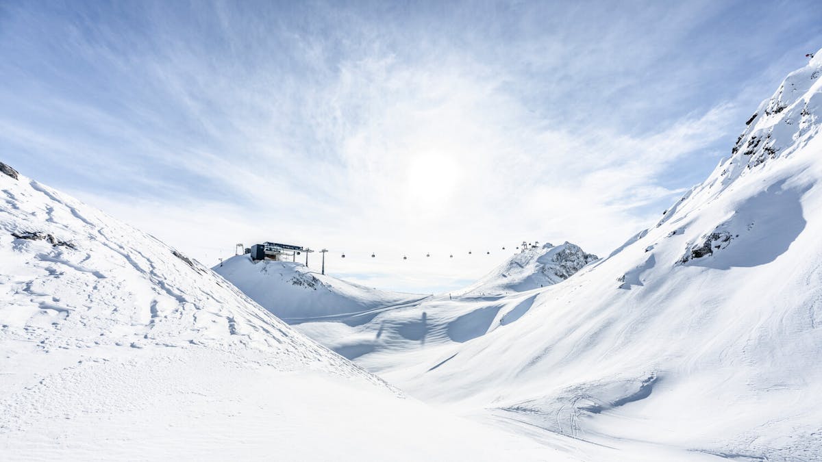 Stunning snowy landscape of St Anton ski resort with chairlifts in background