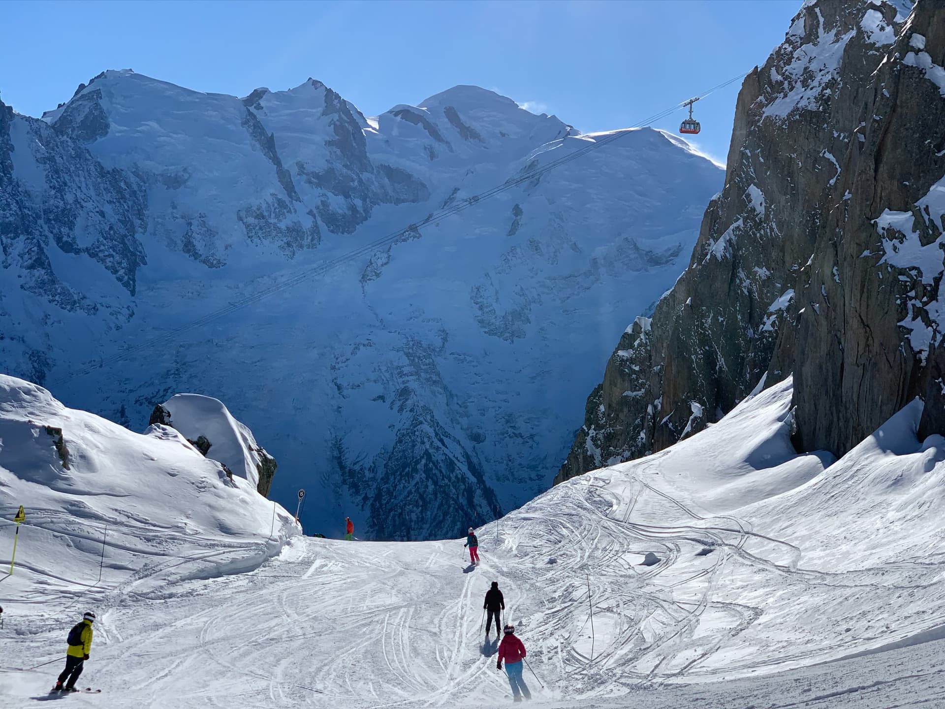 Skiiers skiing down piste in French Alps