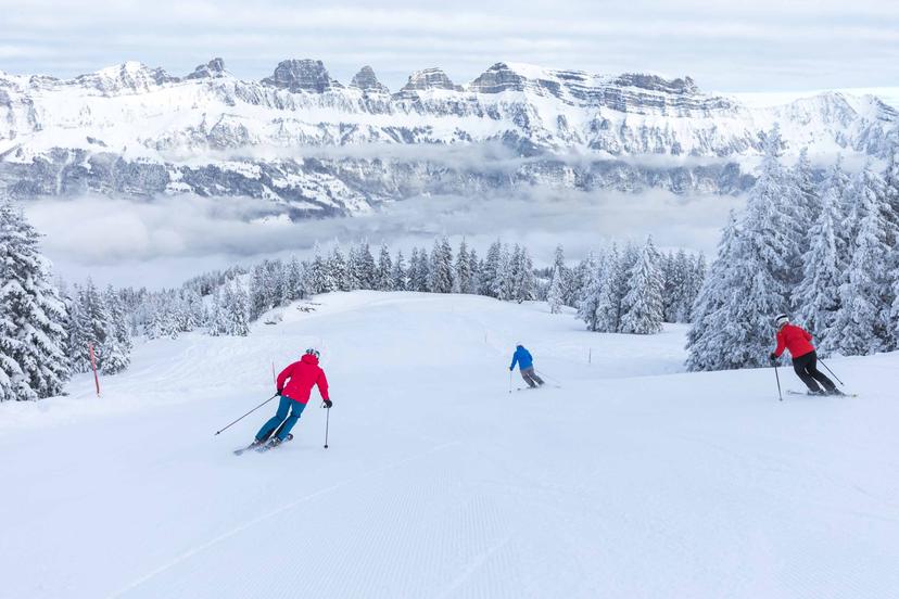 3 Skiiers making their way down slope