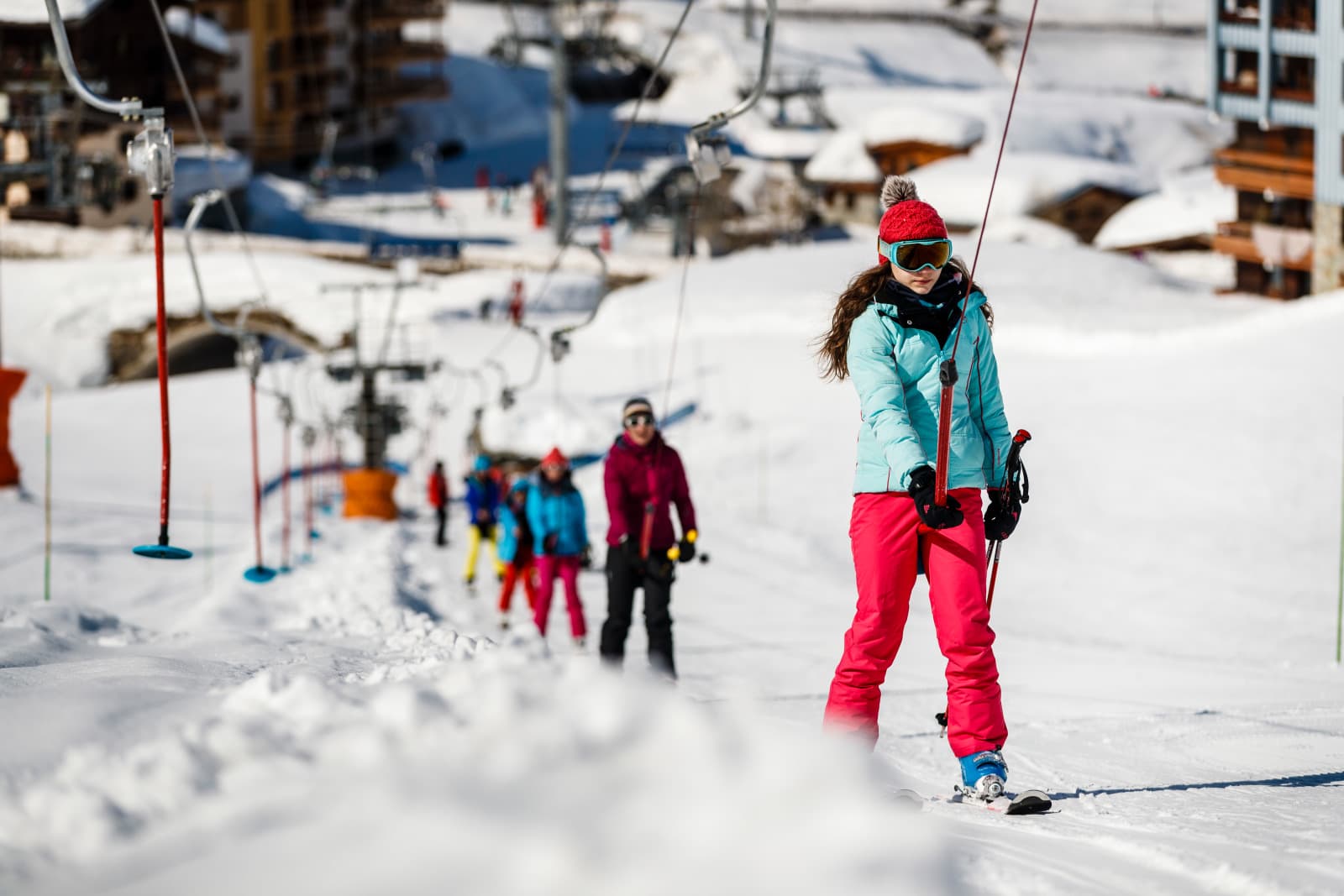 Skier taking T-bar to top of beginner slope in Tignes ski resort