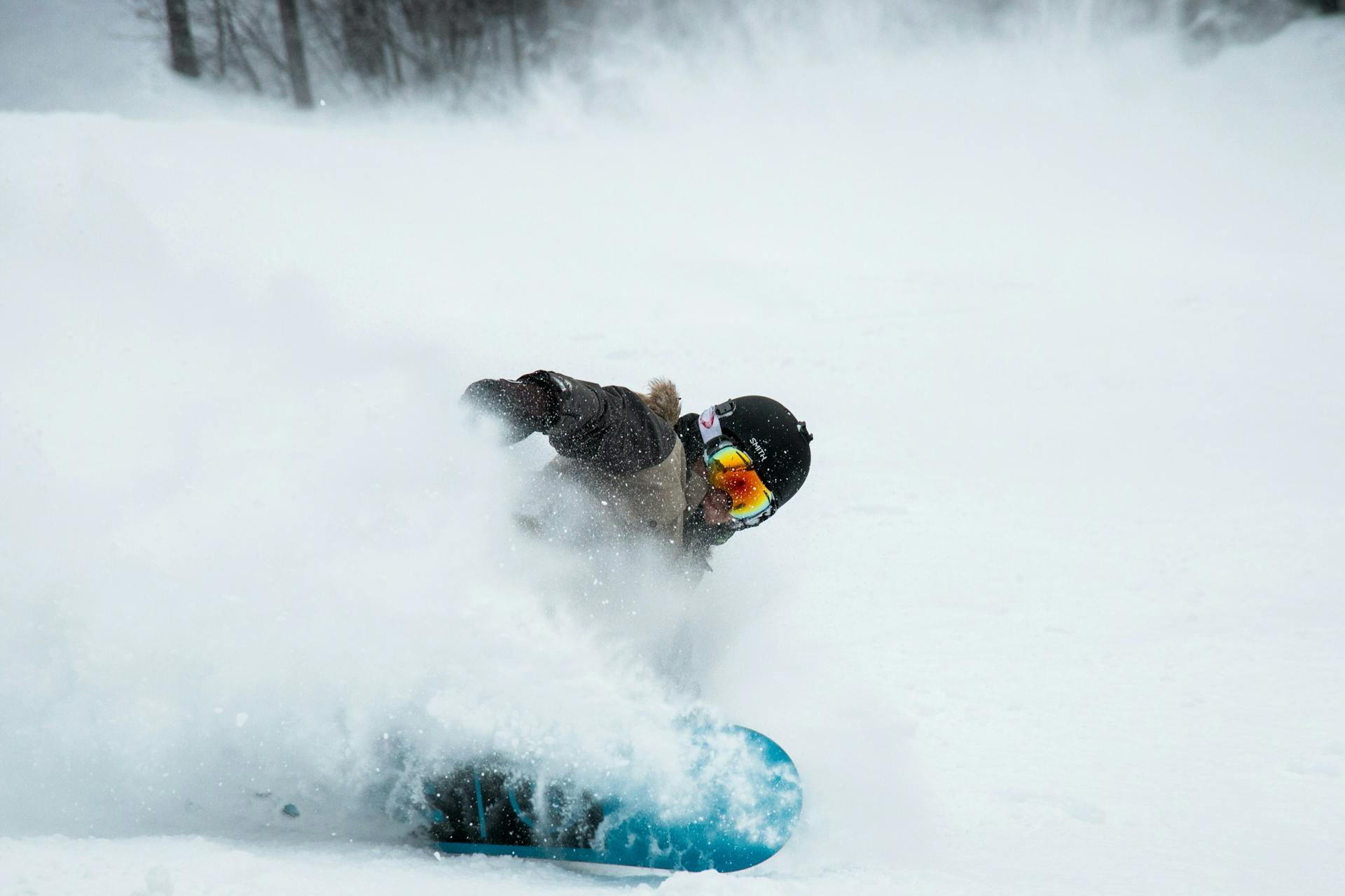 Snowboarder carving powder