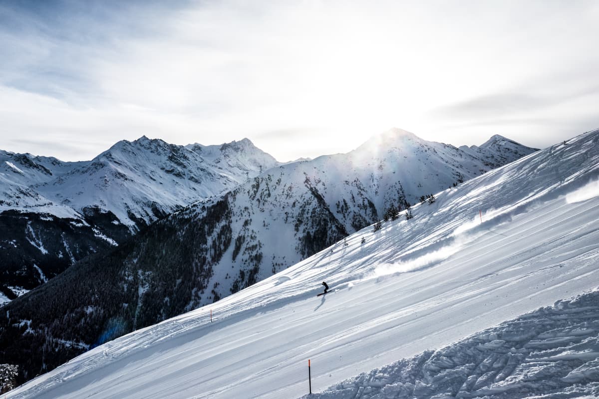 Skier skiing down ski slope in Grimentz ski resort