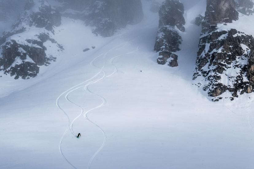 Off piste skier creating fresh tracks in powder