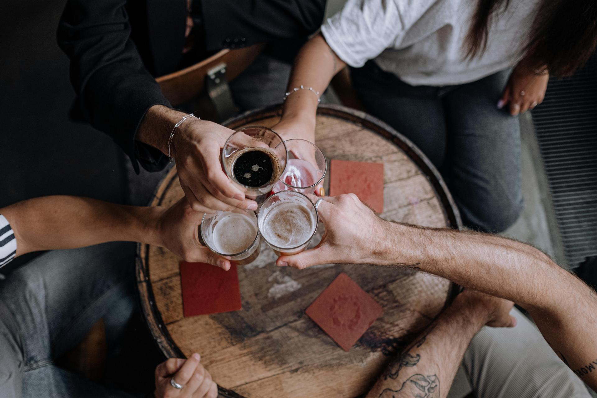 cheers-beer-around-table-friends-bar