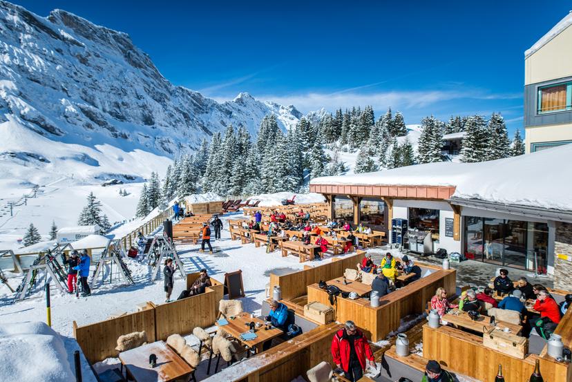 Skiers taking break from skiing to eat lunch