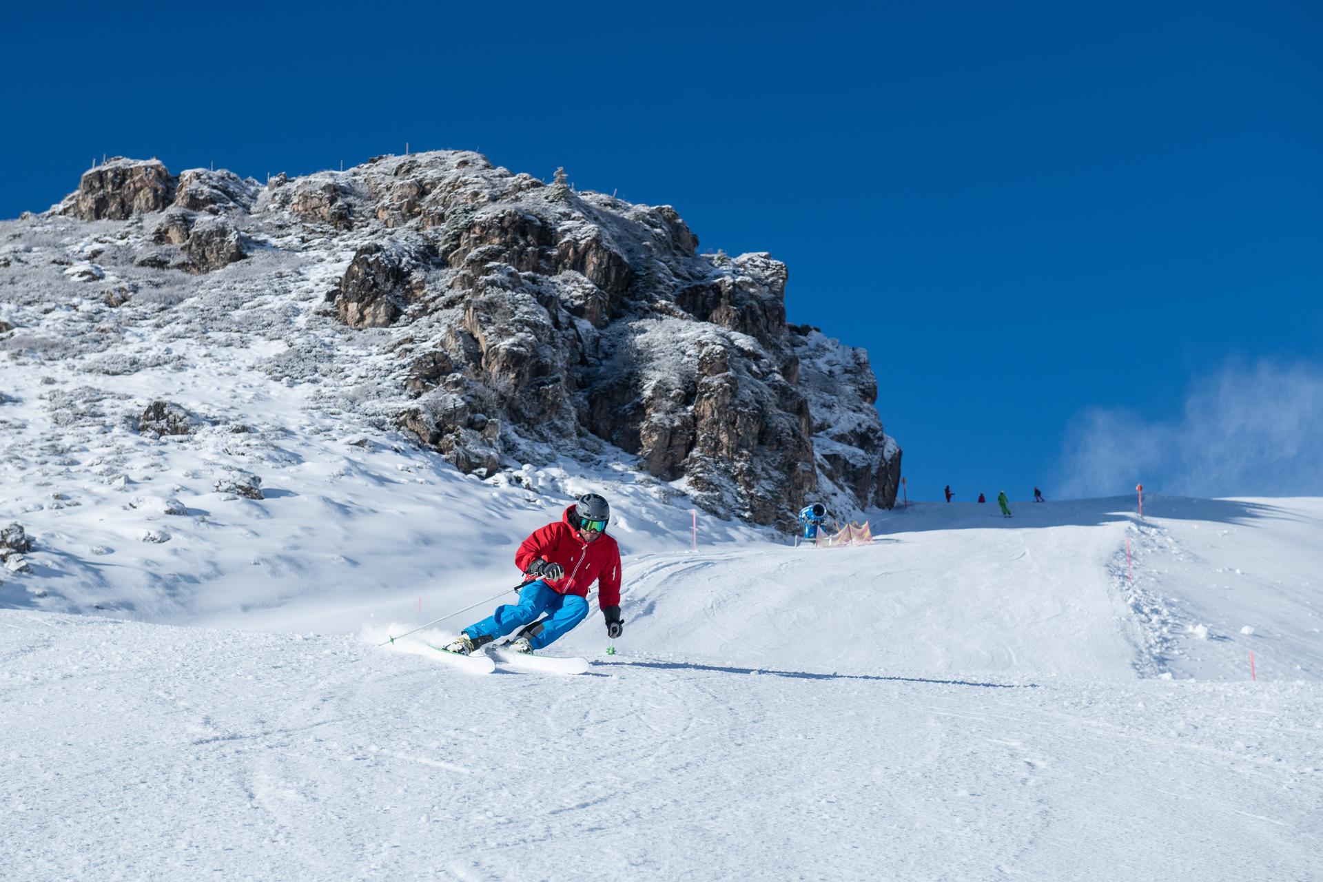 skier carving down kitzski ski area slope