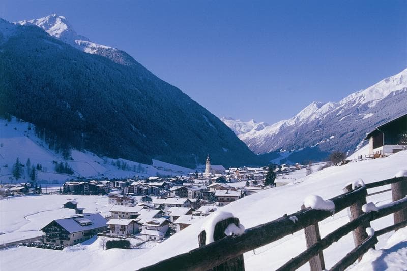 a snow covered valley with beautiful views of the mountains