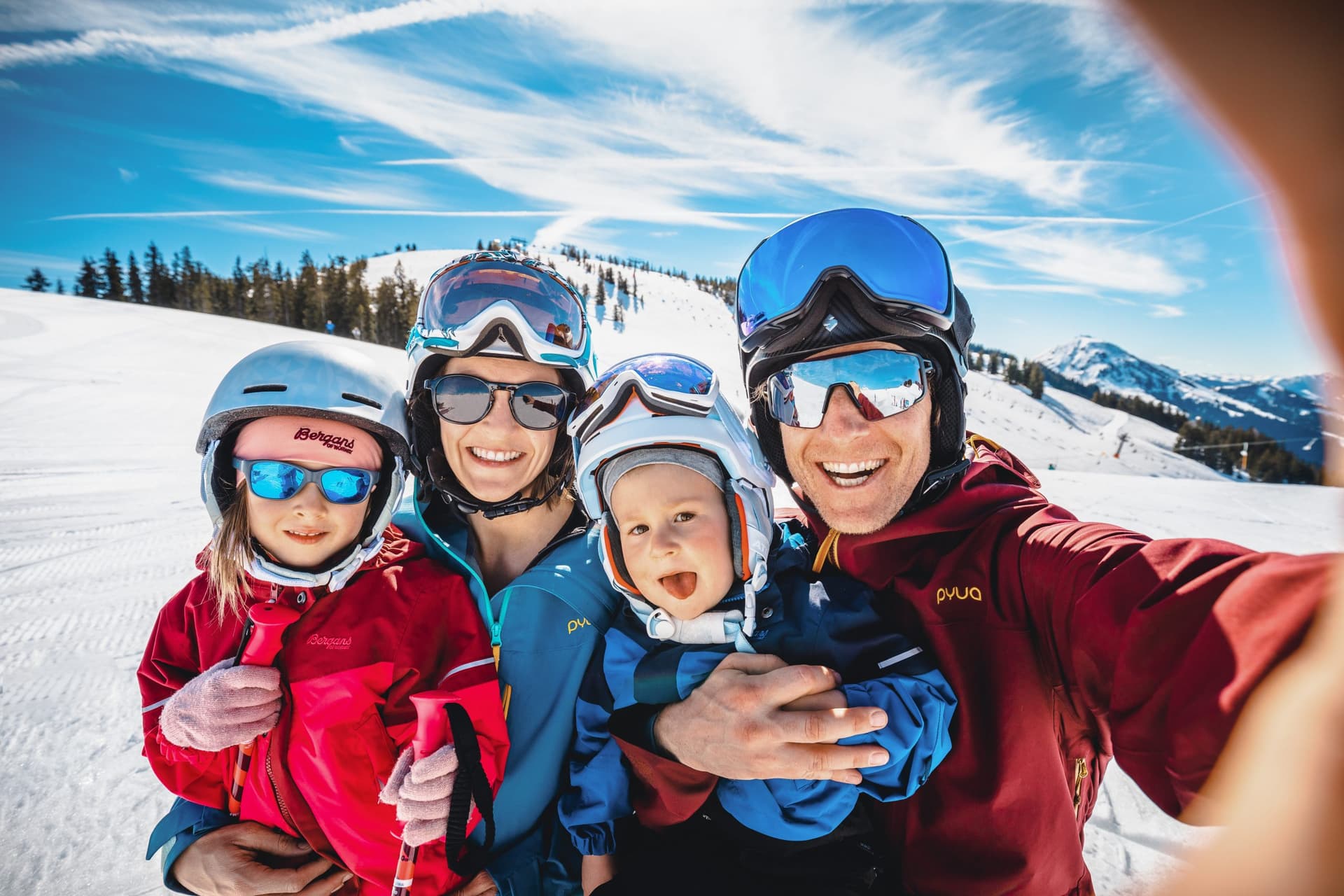 Family smiling while taking a selfie