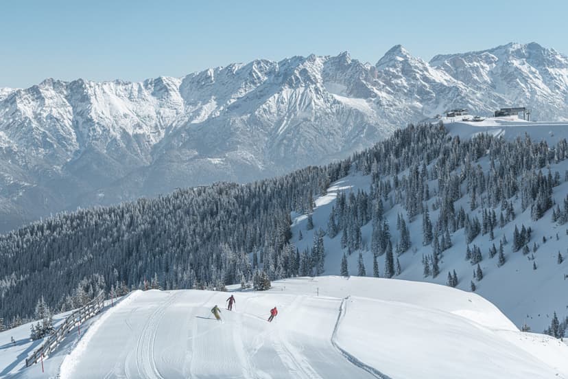 Skiers with mountains in the distance